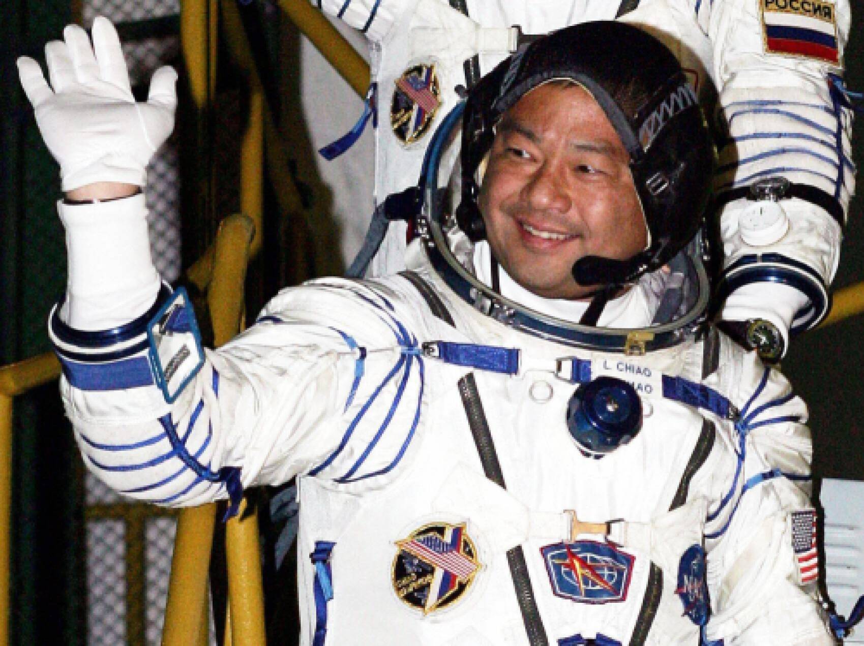 Leroy Chiao waving in suit